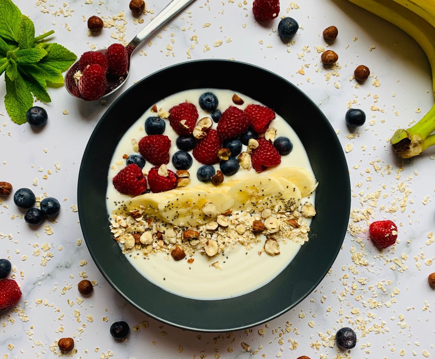 Yogurt bowl with berries, banana, oats and nuts